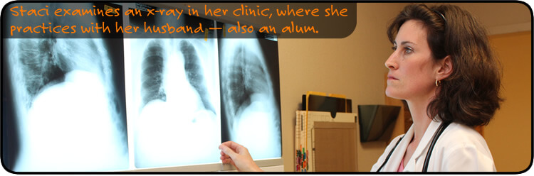 Staci examins an x-ray in her clinic